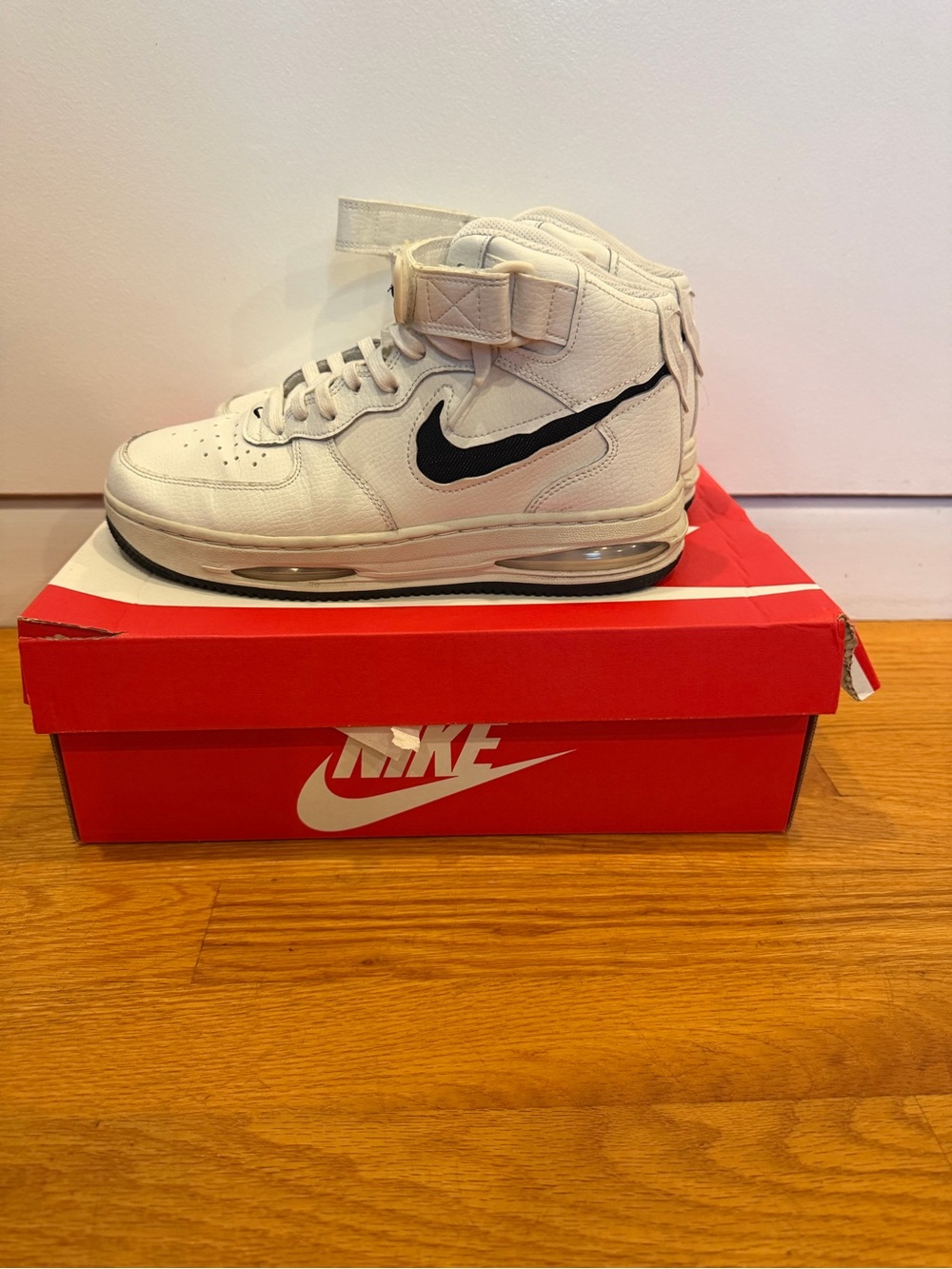Nike White High-Top Sneaker with Black Swoosh